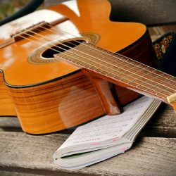 A solo folk singer accompanying herself on guitar